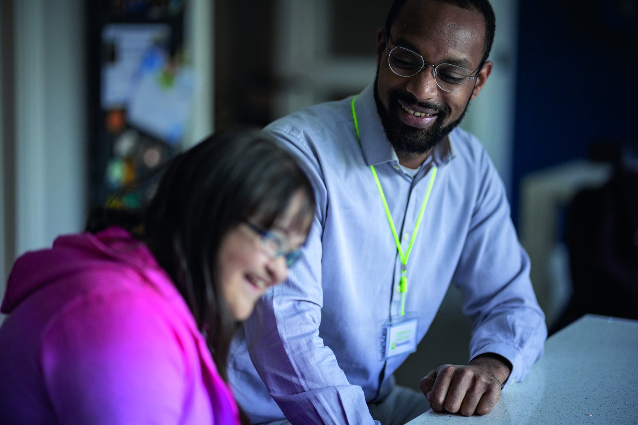 Young person laughing with their support worker